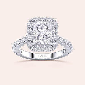 Detailed frontal close-up of radiant-cut halo diamond ring featuring a delicate diamond-accented band in white gold or platinum 