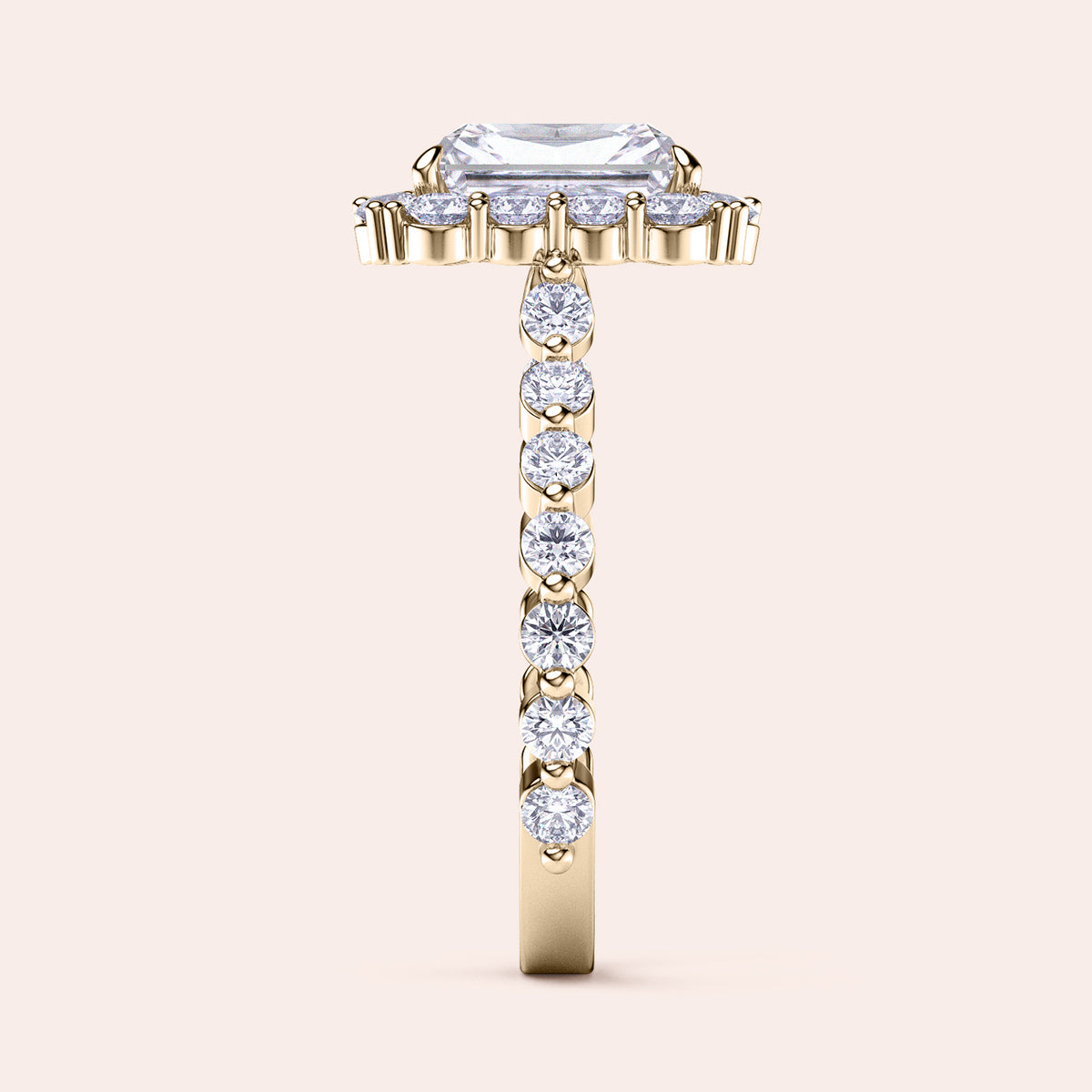 Side view of radiant-cut diamond halo engagement ring showcasing sparkling diamond band in yellow gold 