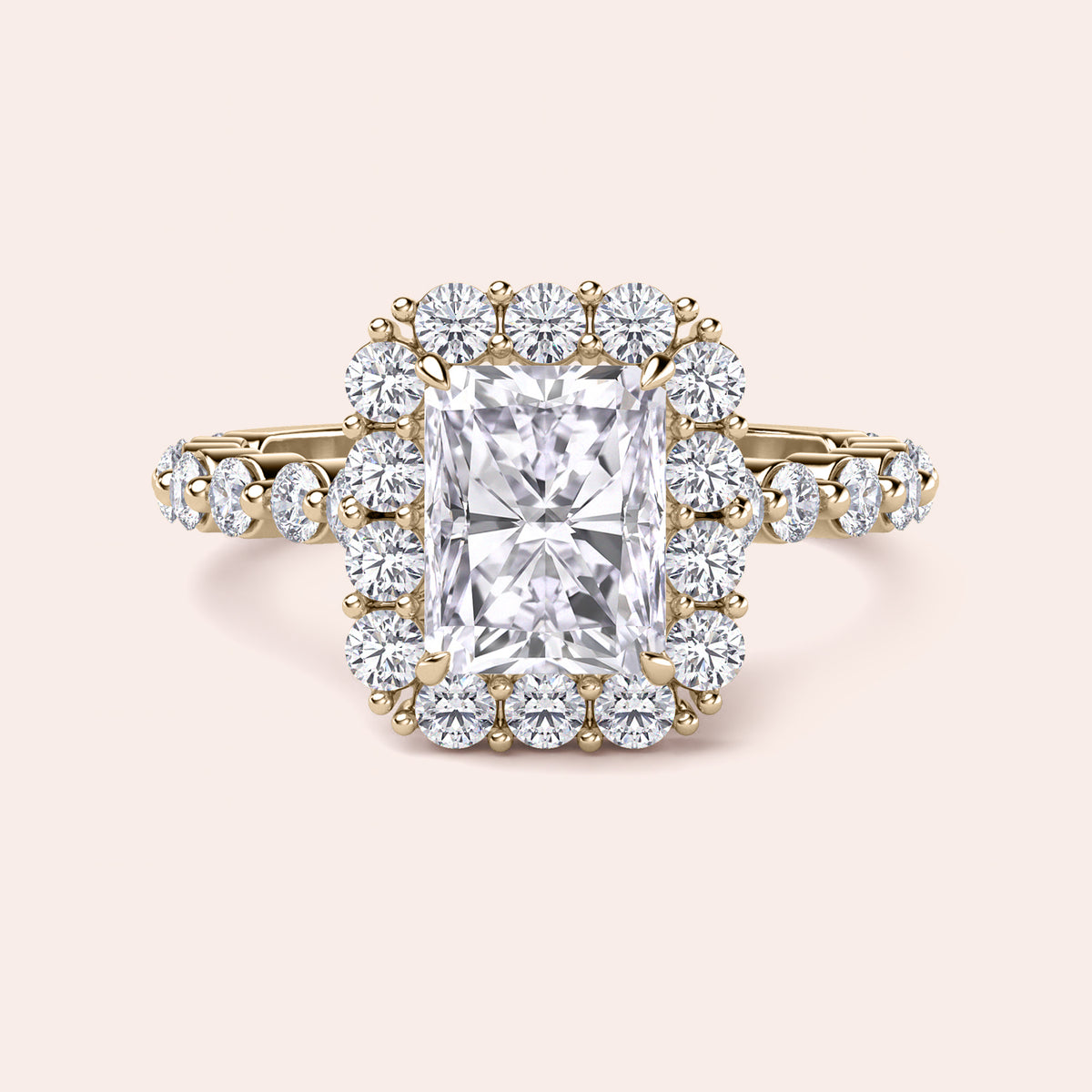 Front view of radiant-cut diamond halo engagement ring surrounded by brilliant diamonds in yellow gold setting 