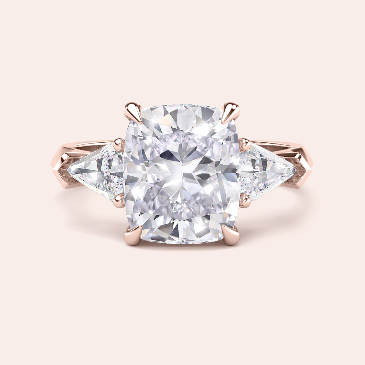 Elegant 14K and 18K rose gold three stone engagement ring featuring a cushion-cut diamond and shield side stones accents.