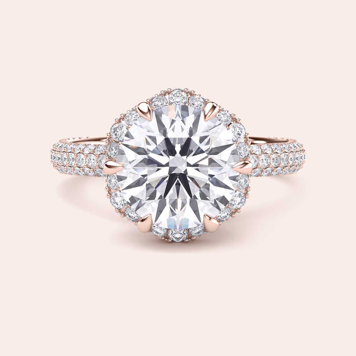 Front view of a luxurious cushion-cut diamond engagement ring in rose gold, adorned with a double halo of diamonds and a sparkling pavé band. 