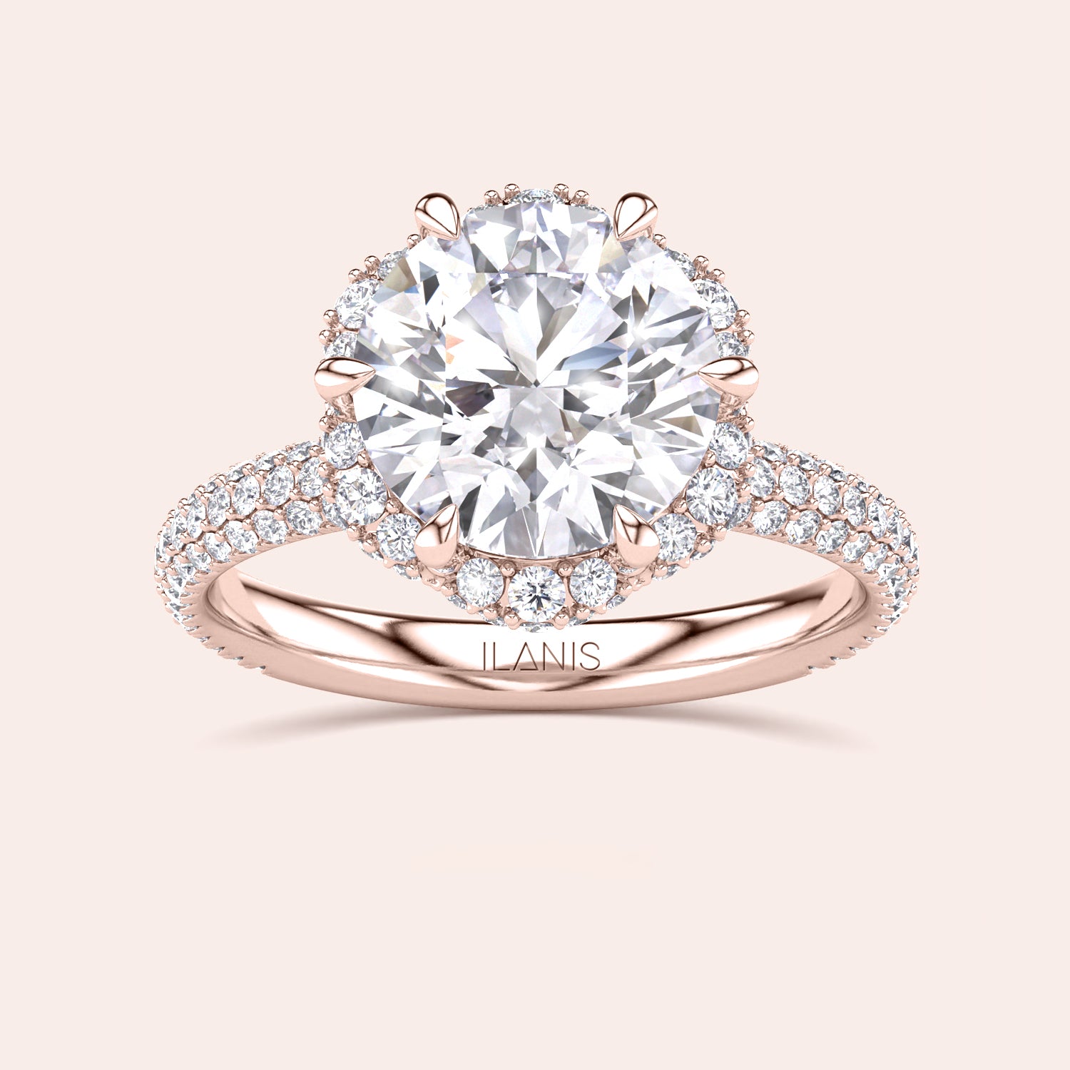 Front view of a luxurious cushion-cut diamond engagement ring in rose gold, adorned with a double halo of diamonds and a sparkling pavé band. | #14KRecycledRoseGold #18KRecycledRoseGold