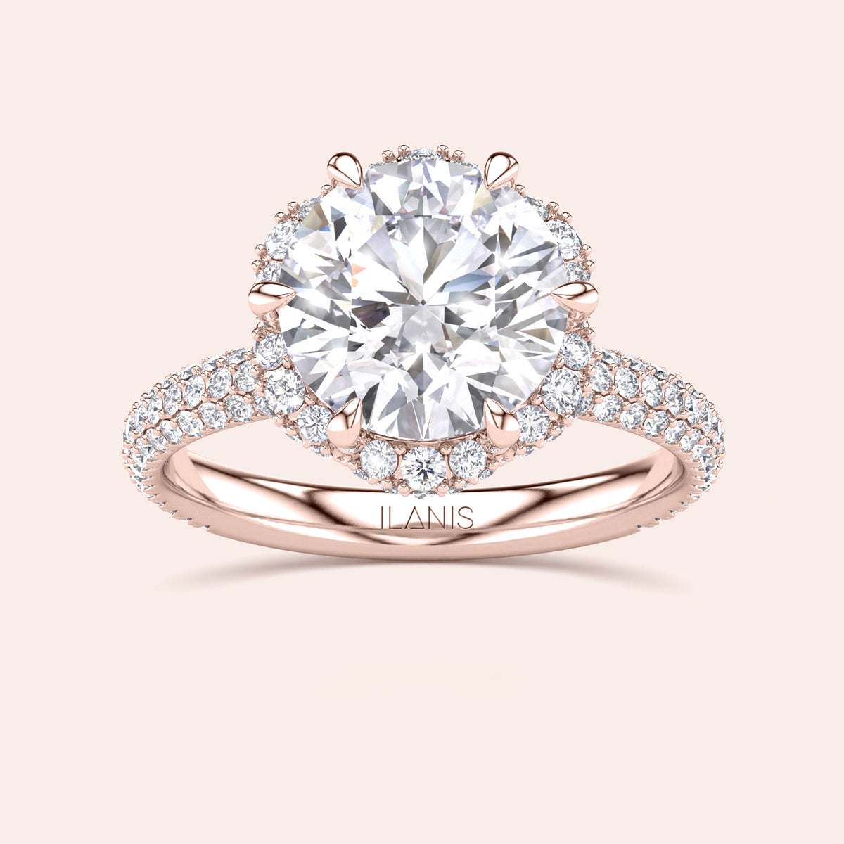 Front view of a luxurious cushion-cut diamond engagement ring in rose gold, adorned with a double halo of diamonds and a sparkling pavé band. 
