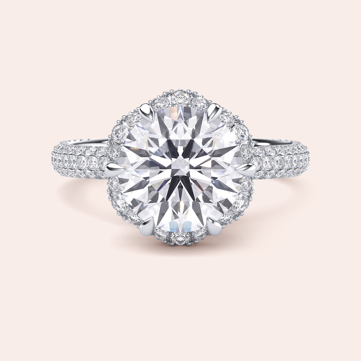 Front view of a luxurious cushion-cut diamond engagement ring in white gold, adorned with a double halo of diamonds and a sparkling pavé band. 