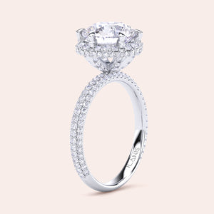 Exquisite white gold engagement ring featuring a halo of pavé-set diamonds around a radiant cushion-cut center stone, mounted on a fully diamond-encrusted band. 
