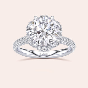Top view of a white gold engagement ring showcasing a cushion-cut diamond encircled by a detailed double halo setting, emphasizing timeless elegance. 