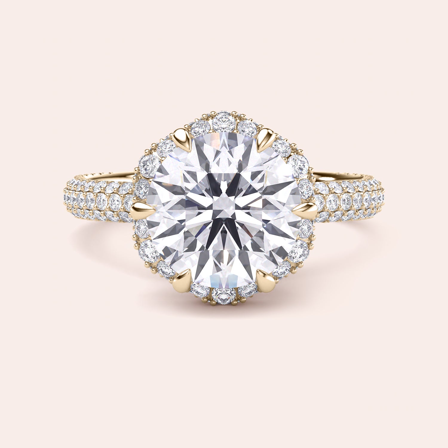 Front view of a luxurious cushion-cut diamond engagement ring in yellow gold, adorned with a double halo of diamonds and a sparkling pavé band. 