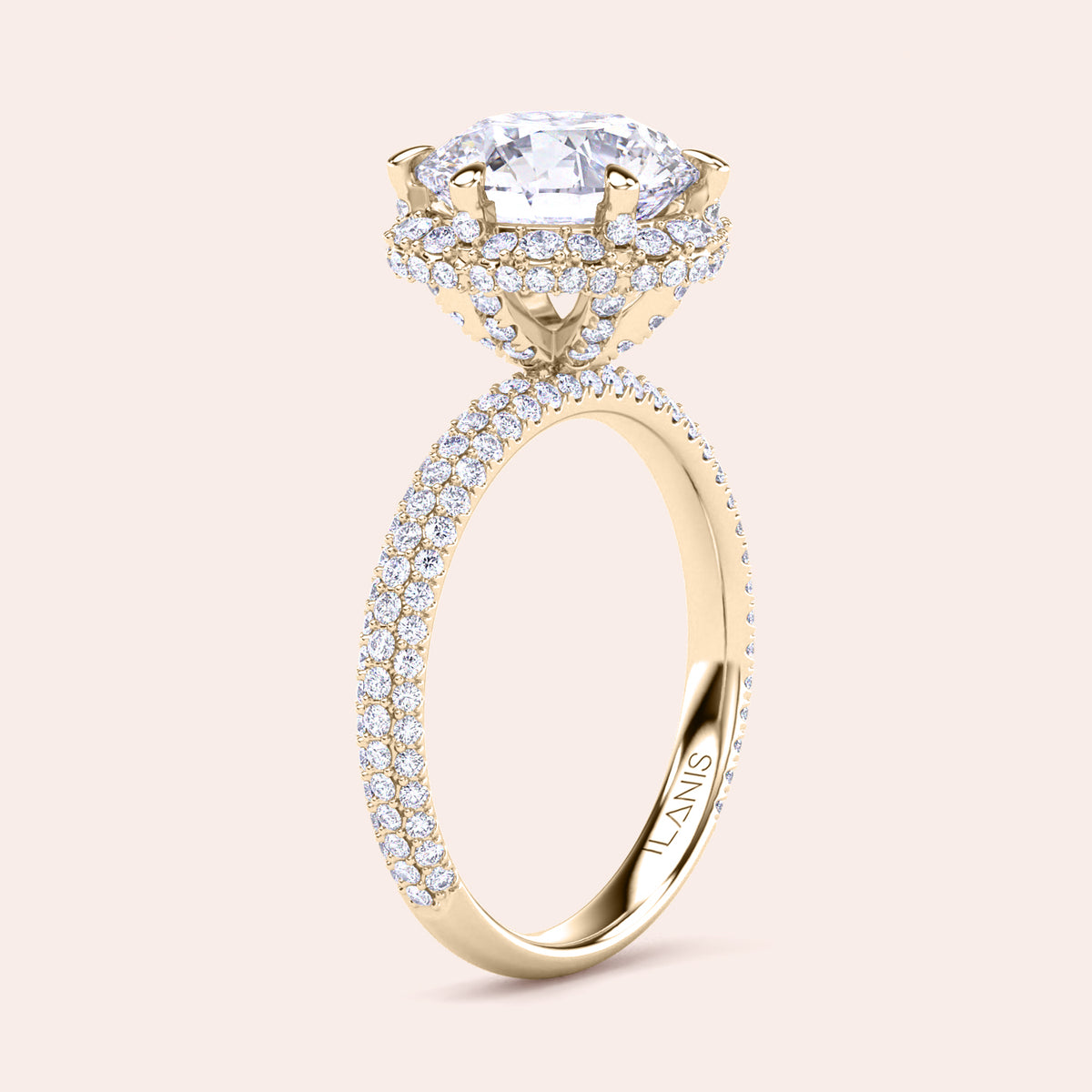 Exquisite yellow gold engagement ring featuring a halo of pavé-set diamonds around a radiant cushion-cut center stone, mounted on a fully diamond-encrusted band. 