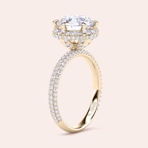Exquisite yellow gold engagement ring featuring a halo of pavé-set diamonds around a radiant cushion-cut center stone, mounted on a fully diamond-encrusted band. 