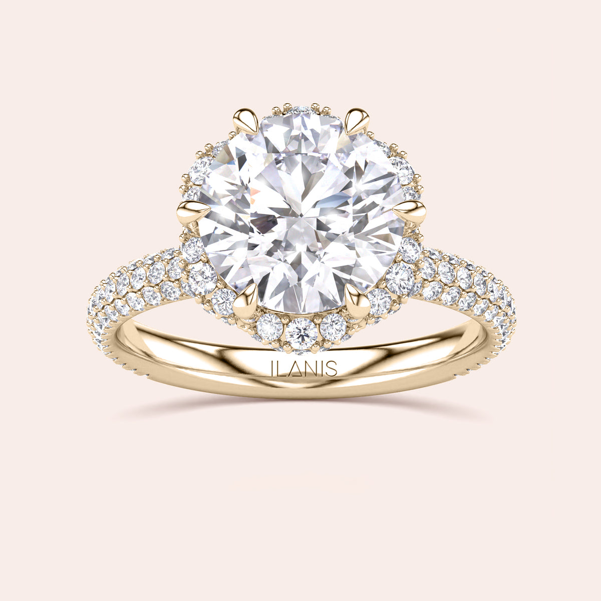 Top view of a yellow gold engagement ring showcasing a cushion-cut diamond encircled by a detailed double halo setting, emphasizing timeless elegance. 