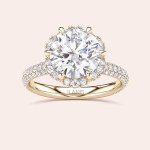 Top view of a yellow gold engagement ring showcasing a cushion-cut diamond encircled by a detailed double halo setting, emphasizing timeless elegance. 
