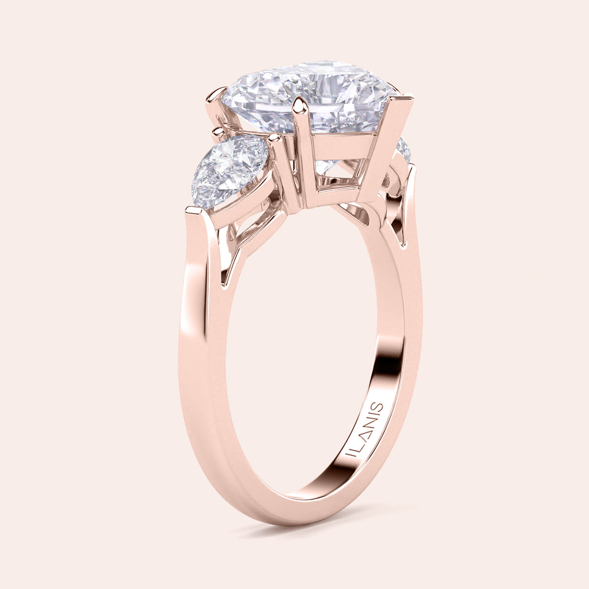 Unique rose gold engagement ring featuring a heart-shaped central diamond flanked by teardrop side diamonds, exemplifying romantic elegance. 