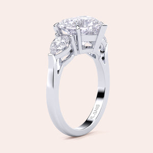 Unique white gold engagement ring featuring a heart-shaped central diamond flanked by teardrop side diamonds, exemplifying romantic elegance. 