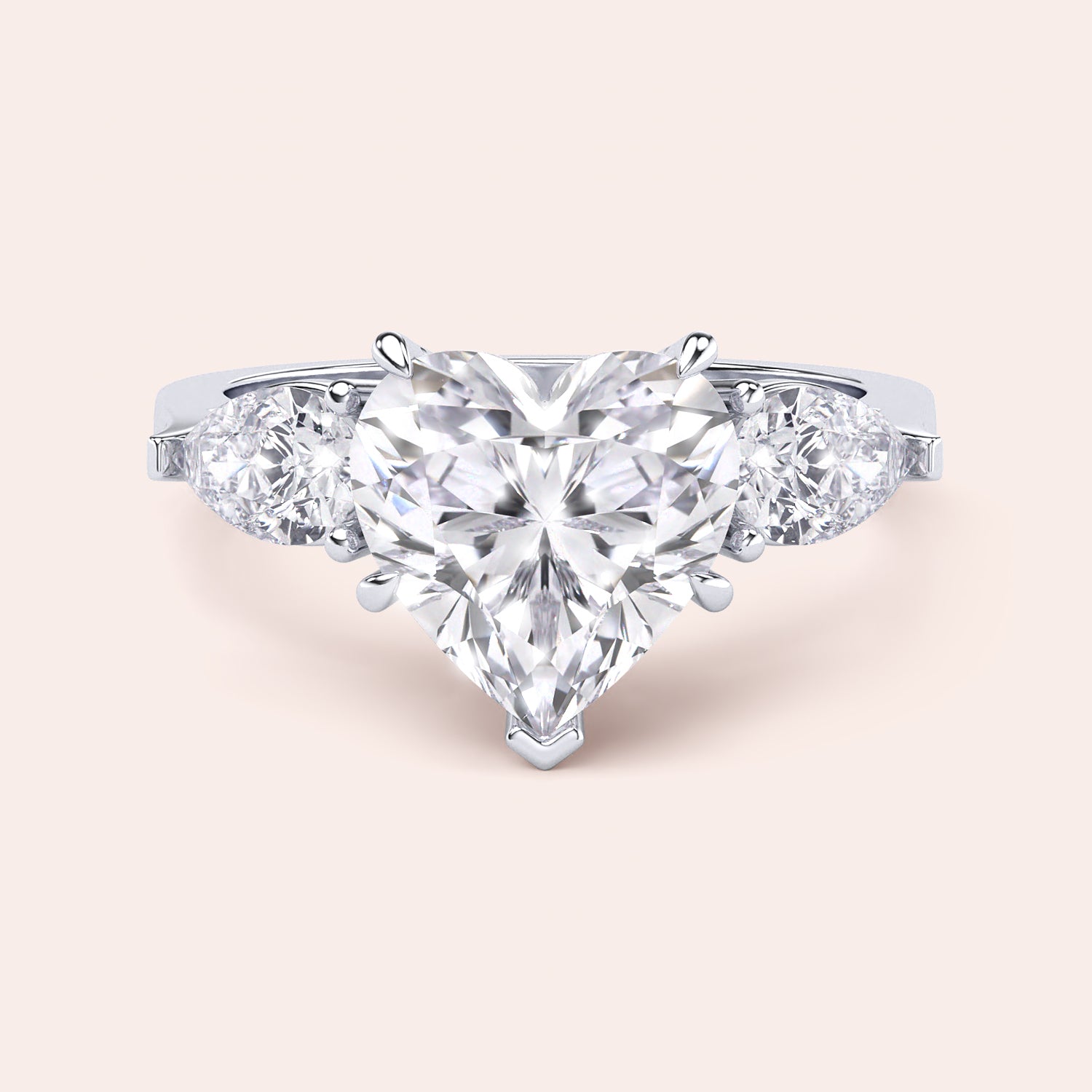 Close-up of a white gold engagement ring with a heart-shaped diamond center and teardrop diamond accents along the band, reflecting sophisticated craftsmanship. | #14KRecycledWhiteGold #18KRecycledWhiteGold #Platinum