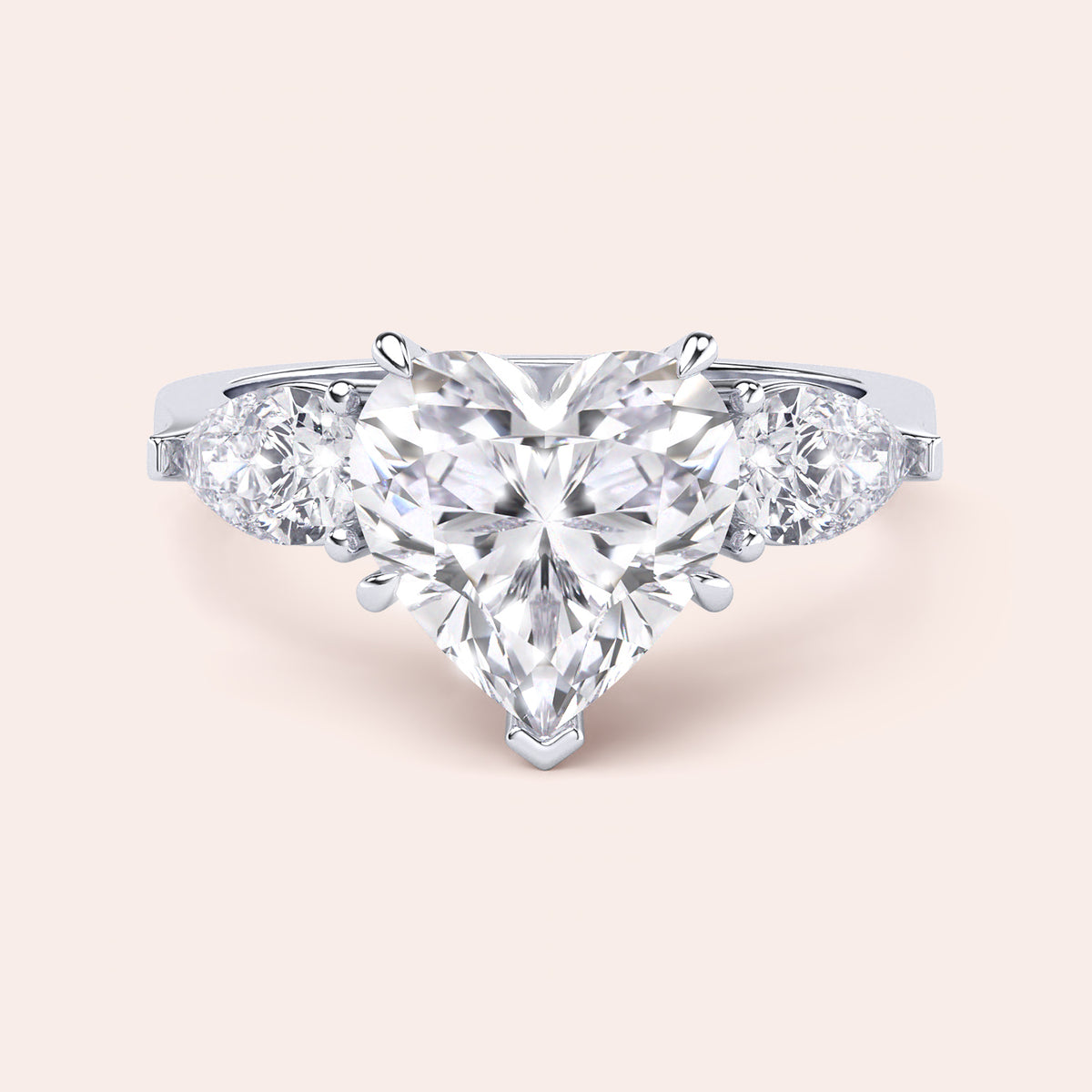 Close-up of a white gold engagement ring with a heart-shaped diamond center and teardrop diamond accents along the band, reflecting sophisticated craftsmanship. 