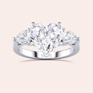 White gold engagement ring with a heart-shaped main diamond and elegant teardrop diamonds, designed for a luxurious and timeless proposal. 