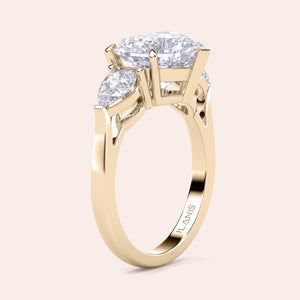 Unique yellow gold engagement ring featuring a heart-shaped central diamond flanked by teardrop side diamonds, exemplifying romantic elegance. 