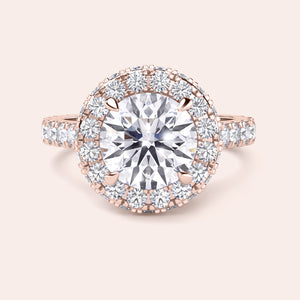 Top view of a rose gold engagement ring featuring a round-cut diamond with a halo, elegantly designed to catch the light and mesmerize. 