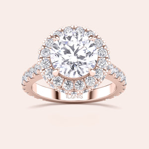 Close-up of a rose gold halo engagement ring, emphasizing the intricate detailing and brilliance of its round-cut diamond centerpiece. 