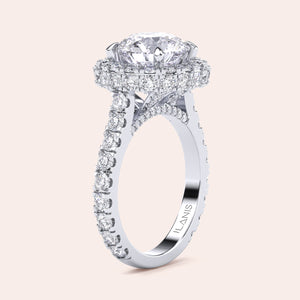 Elegant white gold engagement ring with a brilliant round-cut diamond center, encircled by a dazzling halo of smaller diamonds, adding opulence and sparkle. 