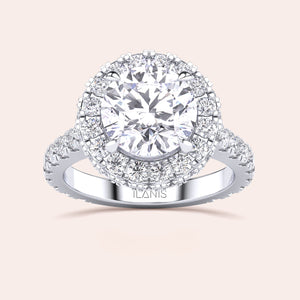 Top view of a white gold engagement ring featuring a round-cut diamond with a halo, elegantly designed to catch the light and mesmerize. 