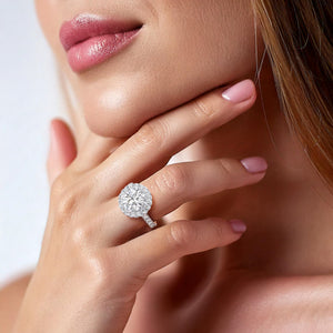 Sophisticated white gold engagement ring with a round-cut diamond and halo setting, showcased on a woman’s finger, symbolizing eternal love. 