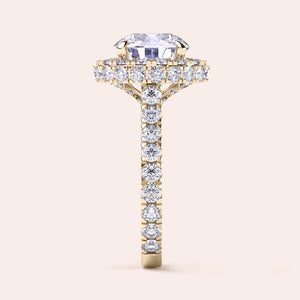 Side view of a yellow gold round-cut diamond halo engagement ring, showcasing a complex halo setting that enhances the ring’s luxury and depth. 