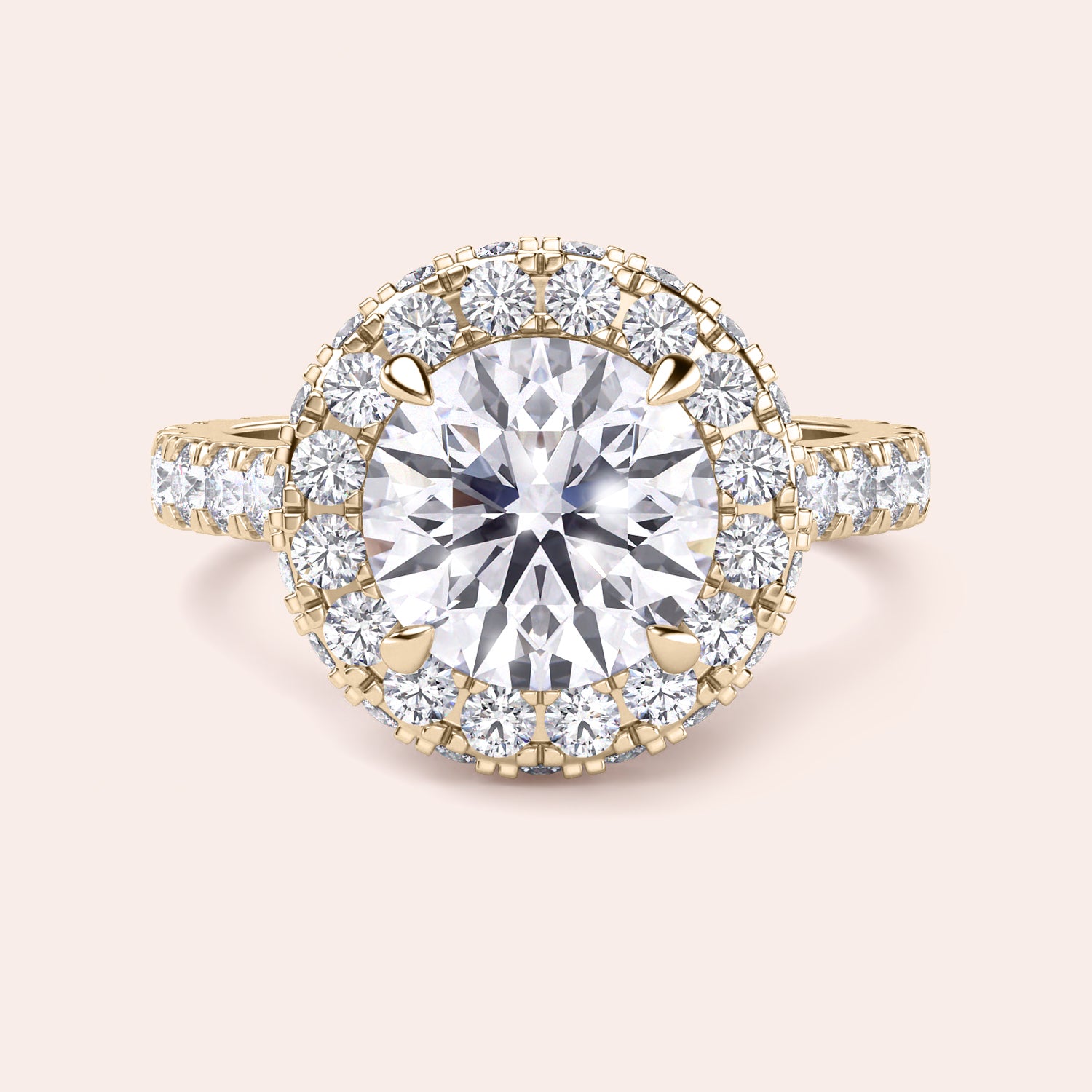 Close-up of a yellow gold halo engagement ring, emphasizing the intricate detailing and brilliance of its round-cut diamond centerpiece. | #14KRecycledYellowGold #18KRecycledYellowGold