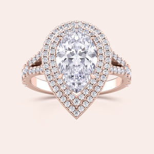 Luxurious rose gold ring with a pear-shaped diamond set in a halo design, accented with a pavé diamond band that splits at the base. #14KRecycledRoseGold #18KRecycledRoseGold