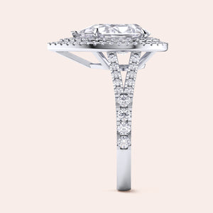 Exquisite white gold engagement ring with a pear-shaped diamond centerpiece surrounded by a shimmering double halo of diamonds, set on a sleek band for a contemporary look. #14KRecycledWhiteGold #18KRecycledWhiteGold #Platinum