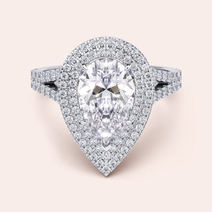 Chic white gold engagement ring displaying a radiant cushion-cut diamond at the center, accented by a delicate pavé setting along the split shank for a glamorous effect. #14KRecycledWhiteGold #18KRecycledWhiteGold #Platinum
