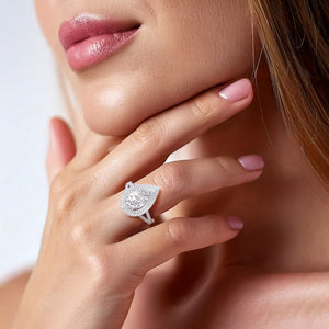 Elegant white gold engagement ring on hand, showcasing a pear-shaped diamond with a double halo setting, symbolizing a promise of everlasting love. #14KRecycledWhiteGold #18KRecycledWhiteGold #Platinum