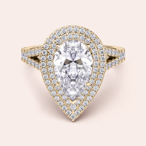 Chic yellow gold engagement ring displaying a radiant cushion-cut diamond at the center, accented by a delicate pavé setting along the split shank for a glamorous effect. #14KRecycledYellowGold #18KRecycledYellowGold