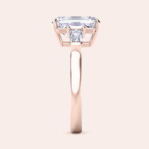 Minimalist yet stunning rose gold engagement ring with a large emerald-cut center diamond, highlighted by its clean and simple design. 