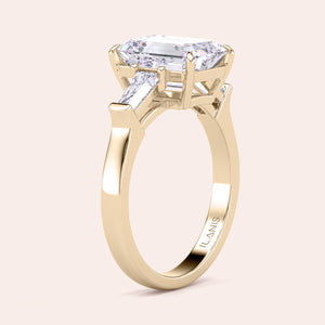 Minimalist yet stunning yellow gold engagement ring with a large emerald-cut center diamond, highlighted by its clean and simple design. 
