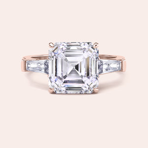 Luxurious rose gold diamond ring showcasing a prominent emerald-cut center stone with side baguettes in a sleek setting 