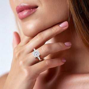 Rose gold engagement ring with a prominent emerald-cut center stone worn on a woman's finger, representing timeless elegance 