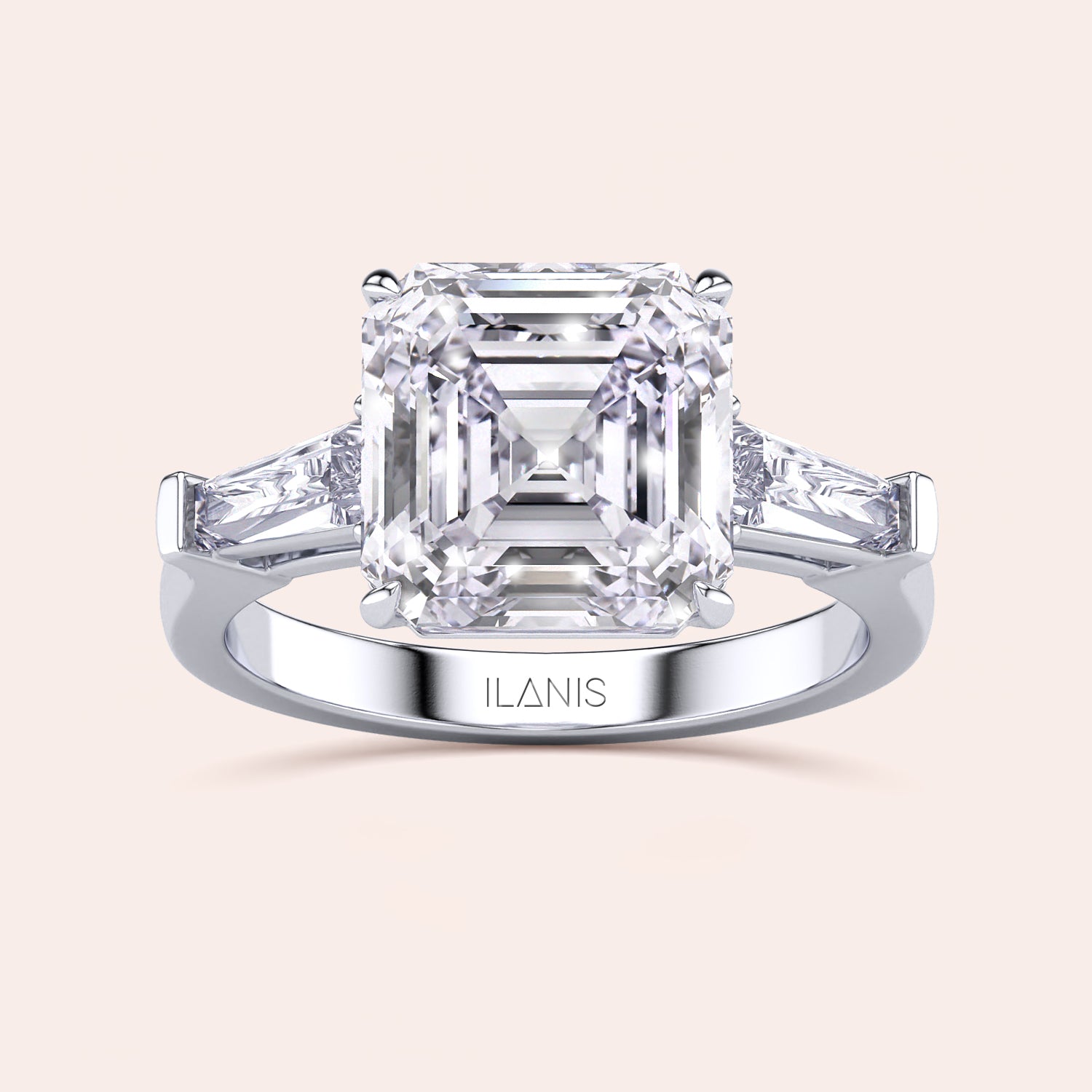 Luxurious white gold diamond ring showcasing a prominent emerald-cut center stone with side baguettes in a sleek setting | #14KRecycledWhiteGold #18KRecycledWhiteGold 
#Platinum