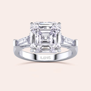 Luxurious white gold diamond ring showcasing a prominent emerald-cut center stone with side baguettes in a sleek setting 