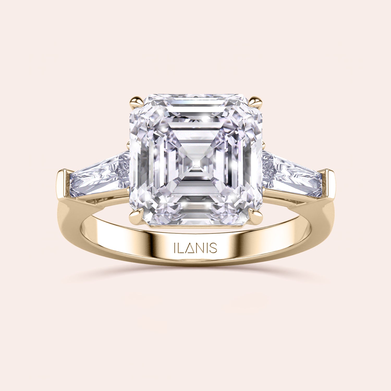 Stunning yellow gold ring with a central emerald-cut diamond flanked by trapezoid diamonds set in a classic design | #14KRecycledYellowGold #18KRecycledYellowGold