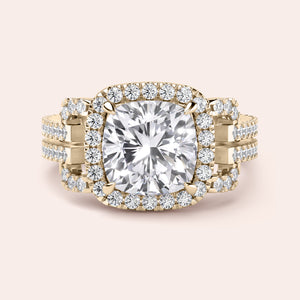 Close-up of a luxurious 14K yellow gold cushion-cut diamond engagement ring with a double halo and intricate detailing.