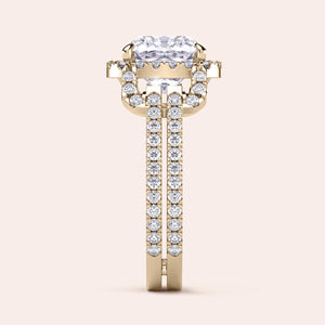 Elegant 14K gold cushion halo split shank engagement ring with round diamonds, showcased against a simple backdrop.