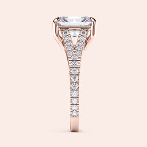 Side view of a rose gold engagement ring with an emerald-cut diamond andPave band. Available in 14K, 18K, or platinum.
