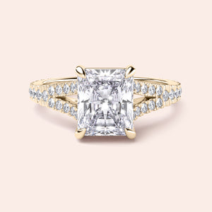 Radiant cut diamond engagement ring in 14K yellow gold with split-shank design and round diamond accents for a stunning look.
