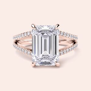 Emerald-cut diamond engagement ring in 14K rose gold, featuring a split shank, hidden halo, and round diamond accents.