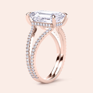 Elegant rose gold engagement ring featuring a sparkling emerald-cut diamond, split shank band, and pave-set diamonds, available in 14K or 18K.
