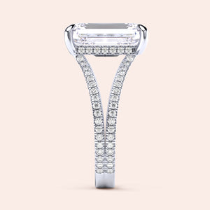 Elegant 14K white gold engagement ring featuring emerald-cut diamond with sparkling accent diamonds on a split shank design.