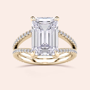 Emerald-cut diamond engagement ring with pave band in 14K or 18K gold, featuring a split shank and hidden halo design.