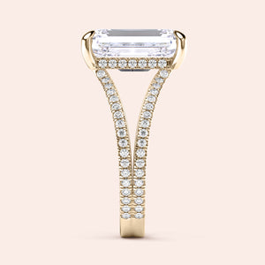 Elegant 14K yellow gold engagement ring with emerald, split shank, hidden halo, and radiant-cut diamond enhancing its exquisite design.