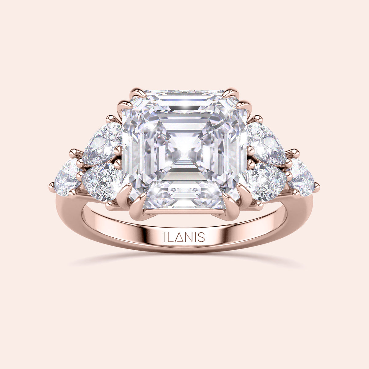 Elegant rose gold engagement ring featuring an asscher and pear cut diamond, surrounded by accent diamonds, in 14K/18K gold or platinum.